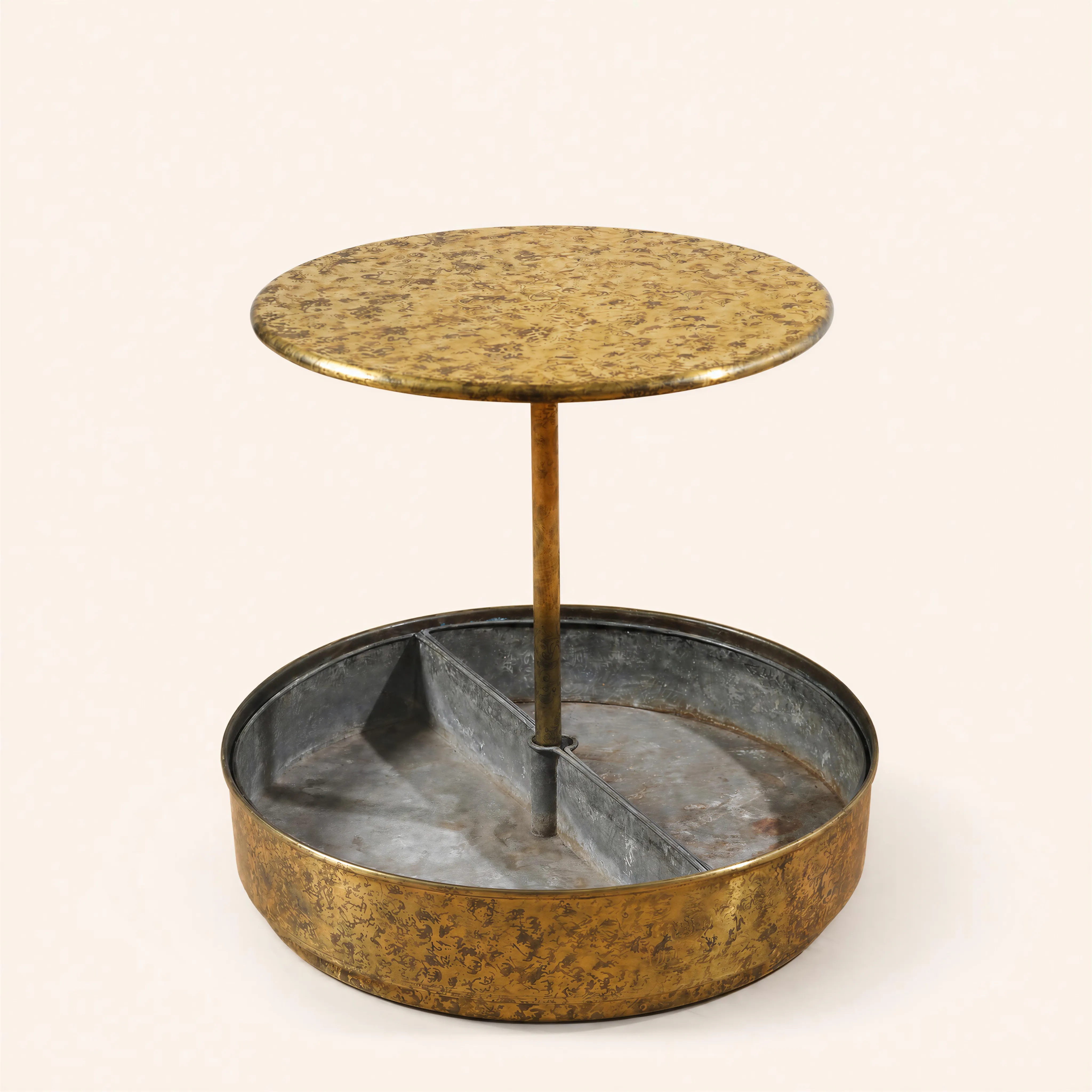 A circular side table made of decorated blond copper. It features a solid upper tray  supported by a single straight vertical central rod. The piece rests on a wide, basin-shaped circular base  that is internally divided into three equal sections by metal partitions.
Illustrated p. 137 & 184 in the book E.Printz, published by Editions du Regard