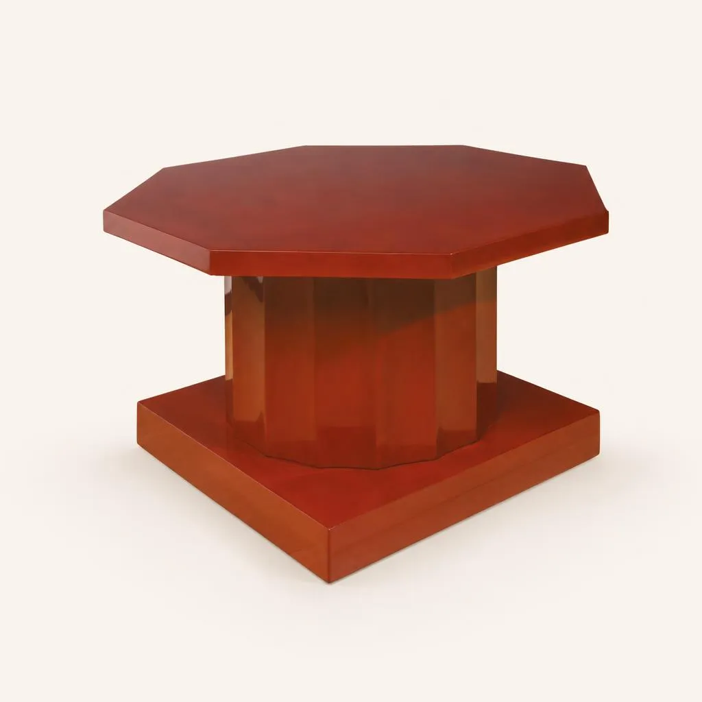 A geometric low side table, known as the "dorique" model, born from the historic collaboration between designer Jacques-Émile Ruhlmann and master lacquerer Jean Dunand. Originally designed in 1913, this unique piece was executed in 1925 for the prominent Lyon silk manufacturer François Ducharne. The table features an octagonal top resting on a powerful central fluted column stem, rigorously evoking the proportions of classical architecture. The entire structure is supported by a thick square plinth base. The oak frame is fully enhanced by a sumptuous, solid dark red lacquer of remarkable sheen and depth, showcasing Jean Dunand's signature craftsmanship.

Drawing from 1913 (ref. 1002 AR/1109 N.R.).
Unique piece.

Bibliography:
Florence Camard, “Jacques-Émile Ruhlmann”, Éditions du Regard, 1983, p. 282.
Félix Marcilhac, “Jean Dunand”, Éditions de L’Amateur, 1991, p. 252, no. 473.