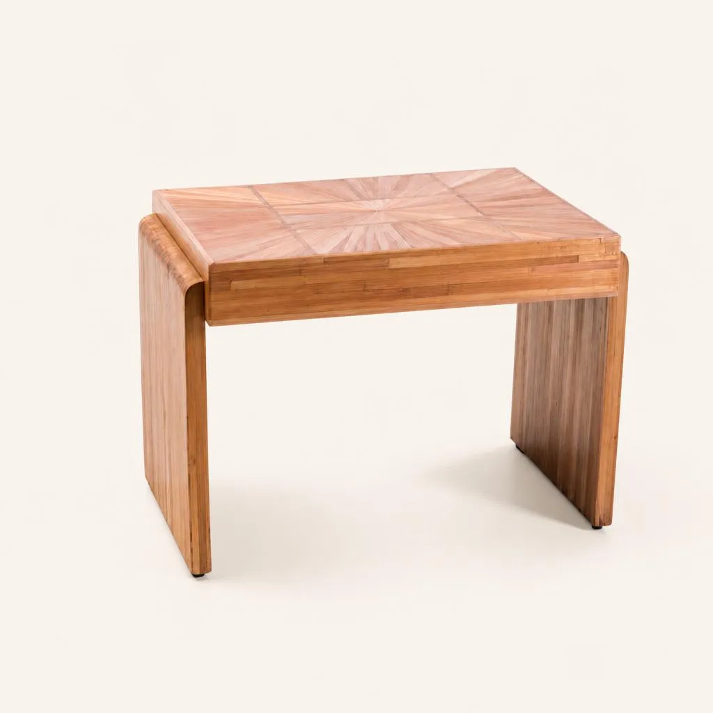 A low table fully covered in fine straw marquetry. The rectangular top features a central sunburst motif framed by geometric panels. The rounded side panels display vertical straw inlay. 