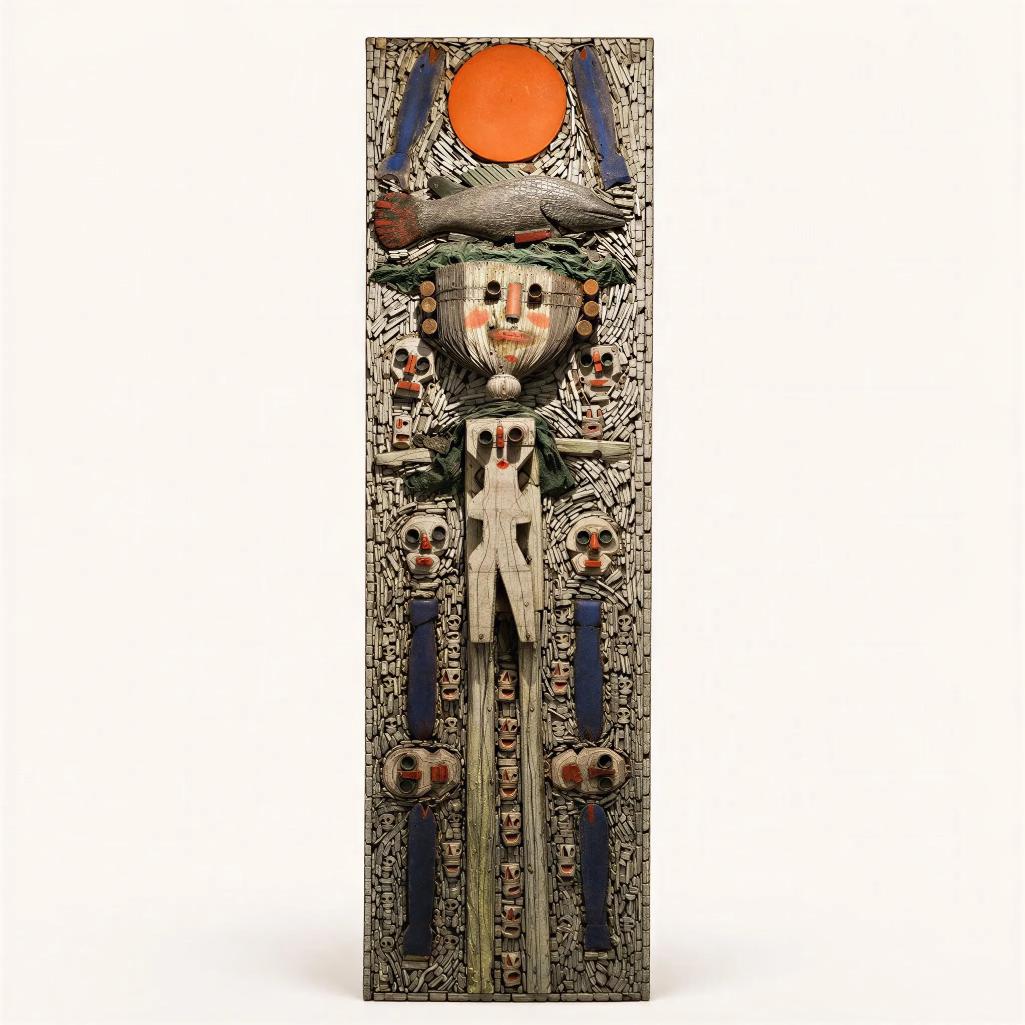 A vertical mixed-media assembly on a wooden panel. The piece features a stylized anthropomorphic central figure carved in relief from white-painted wood, topped with a fish motif and an orange celestial disc. The background consists of a dense mosaic of small raw and painted wooden elements, framed by four purple vertical rectangles flanking the main figure. Several miniature faces are integrated around the central character. 
Signed and dated on the reverse.